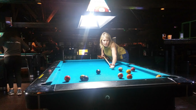 Player lining up a shot on a coin-op table at 1739 Public House