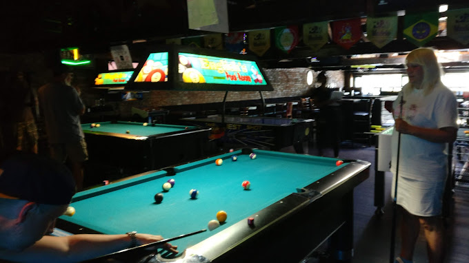Row of coin-op pool tables in play on a league night at 1739 Public House