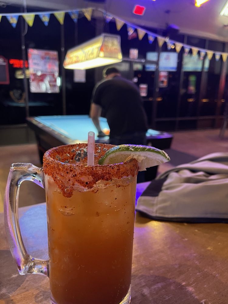 Michelada on the rail while a player shoots pool at Gardens Bar and Grill