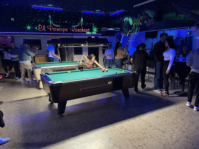 Three coin-op pool tables running on a busy night at El Principe in San Pedro